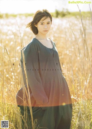A woman in a white sweater is smiling in a magazine.