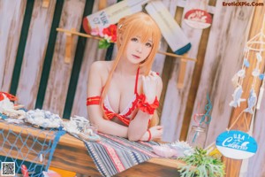 A woman in a red and white bikini posing for a picture.
