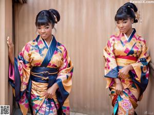 A woman in an orange and blue kimono posing for a picture.