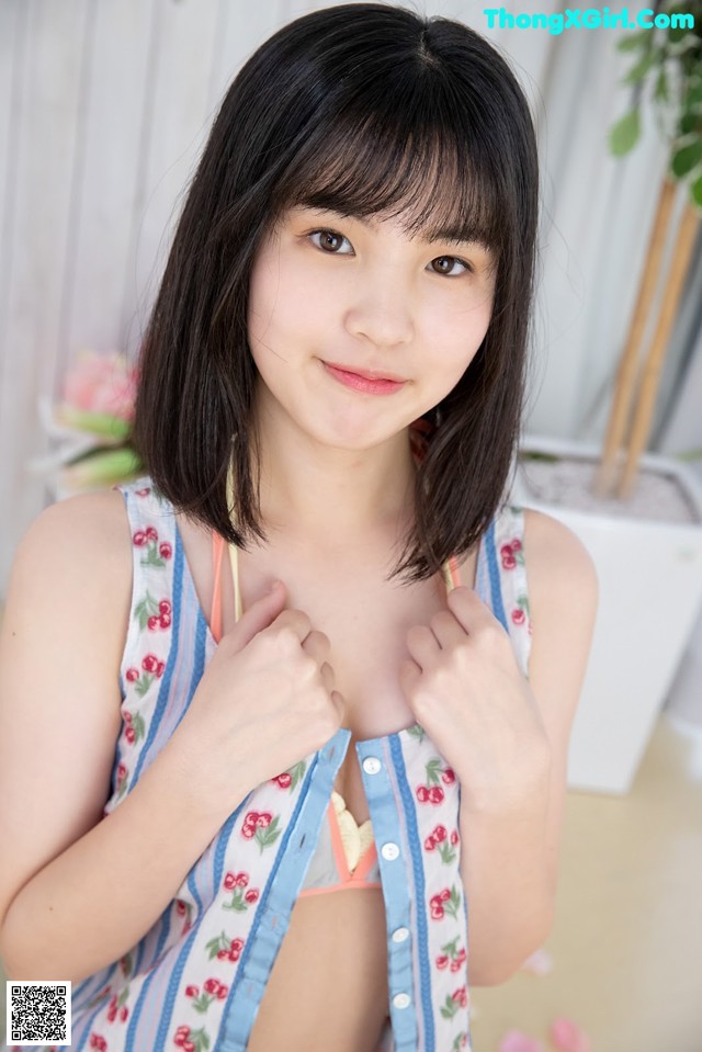 A woman in a blue and white striped shirt posing for a picture.