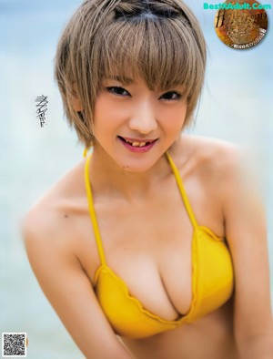 A woman in a red and white striped bikini posing for a picture.