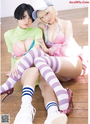A couple of women in bikinis sitting on top of a couch.