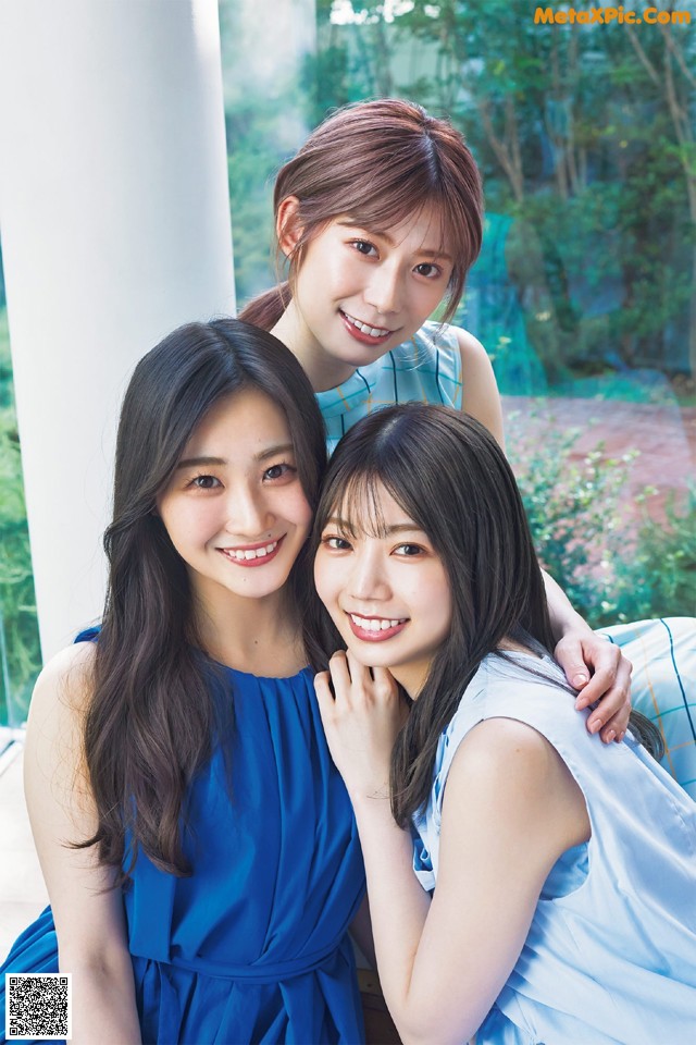 A group of three young women posing for a picture.