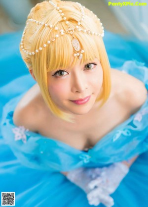 A woman in a blue dress posing for a picture.