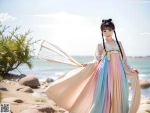 A woman in a pink hanbok is posing for a picture.