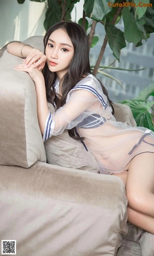 a woman sitting on top of a wooden bench next to a plant