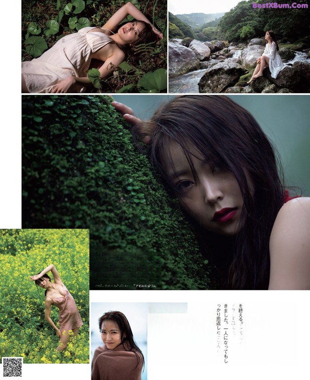 A woman laying on a rock in a field of flowers.