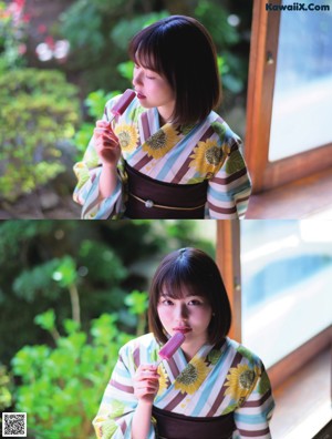 A woman in a kimono standing in front of a wall.