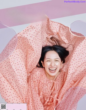 A magazine spread with a woman holding a bouquet of flowers.